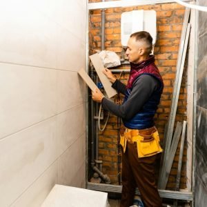 industrial-tiler-builder-worker-installing-floor-tile-at-repair-renovation-work-.jpg