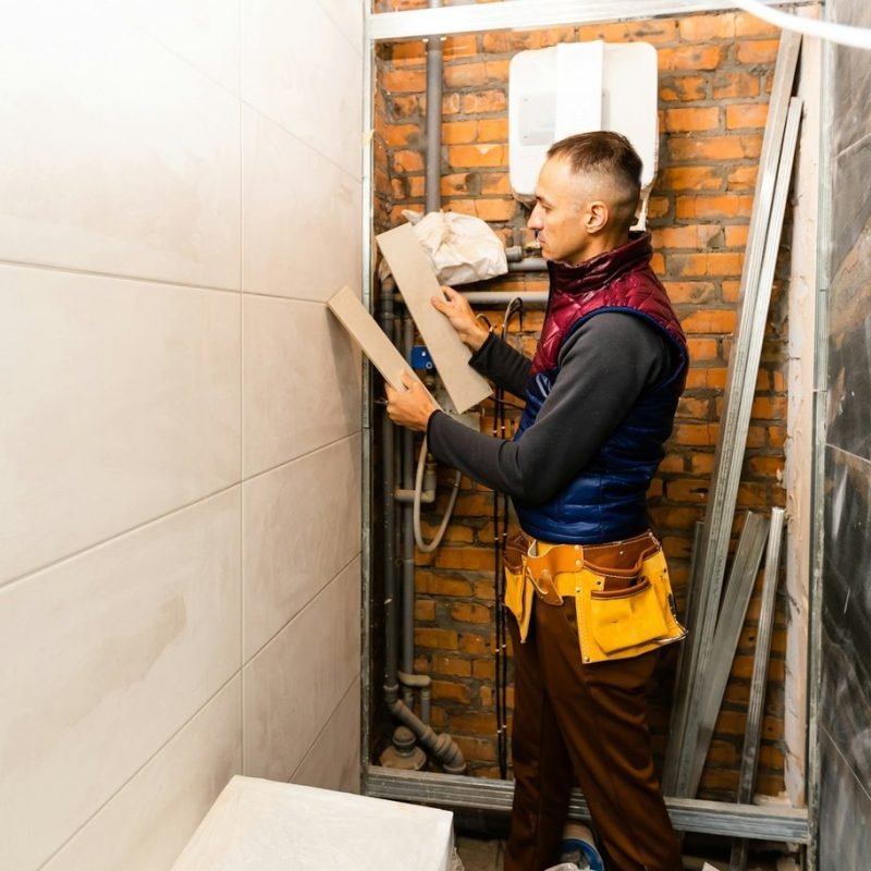 industrial-tiler-builder-worker-installing-floor-tile-at-repair-renovation-work-.jpg